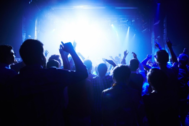 This concert is next level. A crowd of people cheering the band on stage