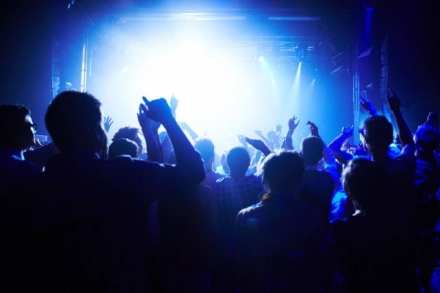 This concert is next level. A crowd of people cheering the band on stage